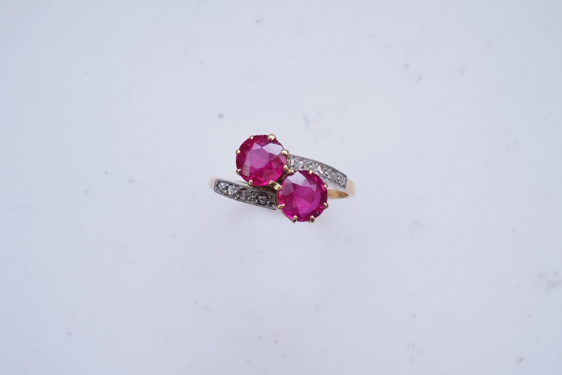 A synthetic ruby and diamond 'toi-et-moi' ring, early 20th century